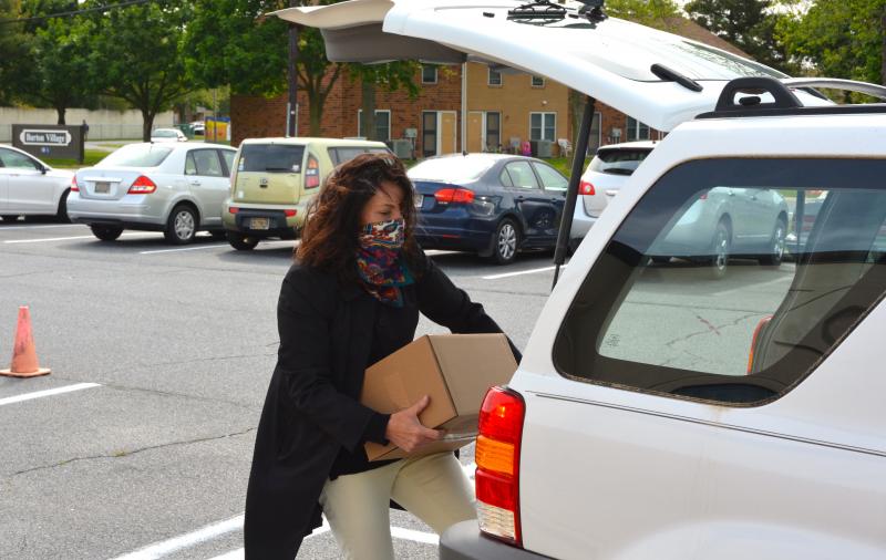 State Auditor Kathy McGuiness loads a box in the back of a vehicle May 19. The food was distributed by the Food Bank of Delaware in partnership with the Sussex Family YMCA. CHRIS FLOOD PHOTOS